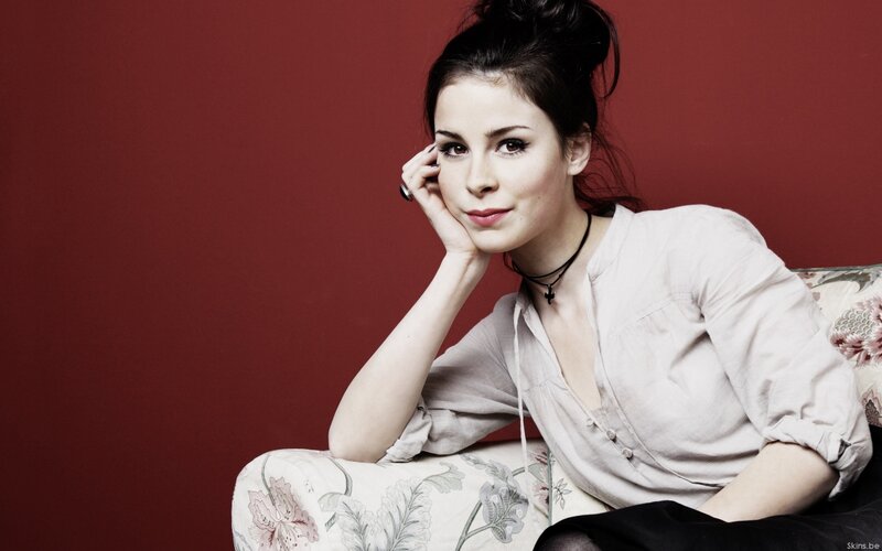 woman with dark hair on floral couch