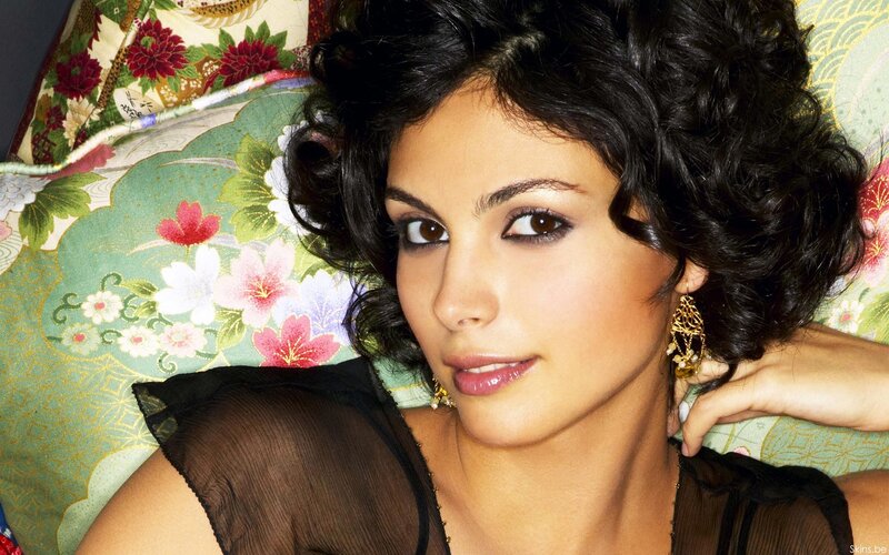 woman with dark hair on floral pillow