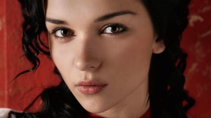 Woman with Dark Hair — Red, Serious, Photograph