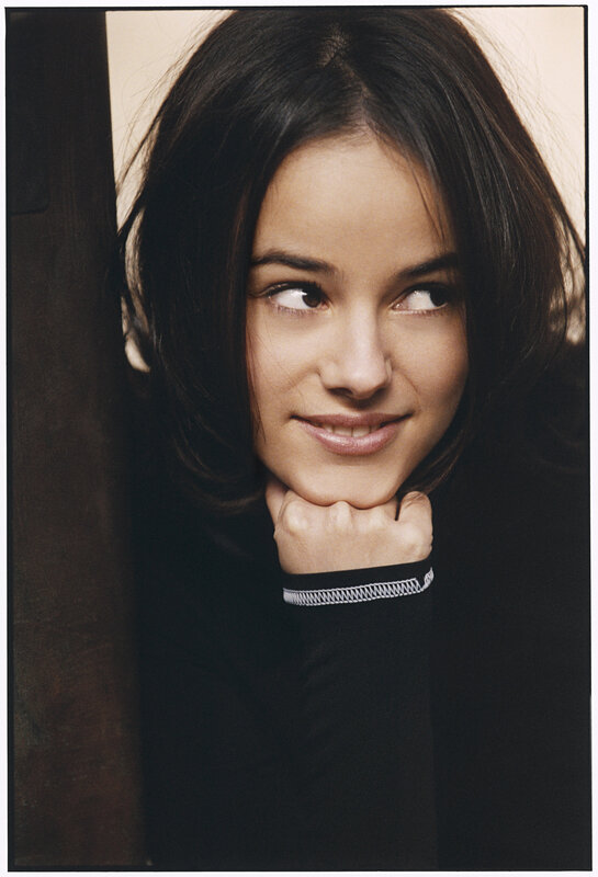 woman with dark hair resting chin on hand