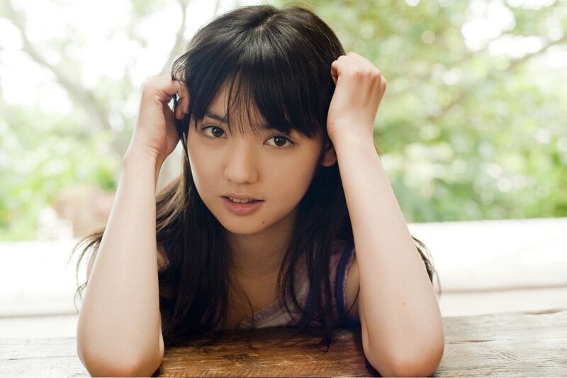 woman with dark hair resting on table