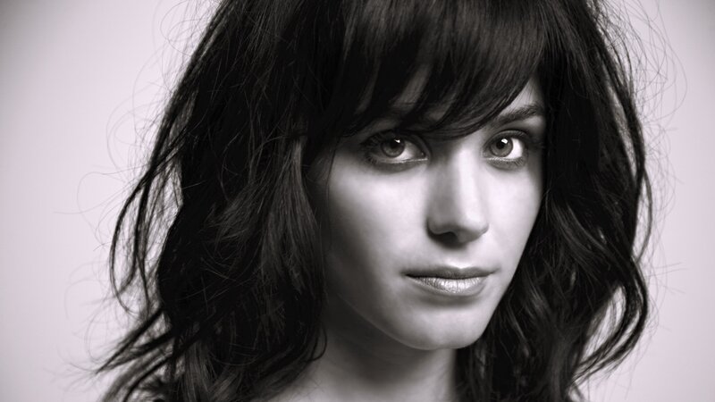 Woman with Dark Hair — Serious, Gray
