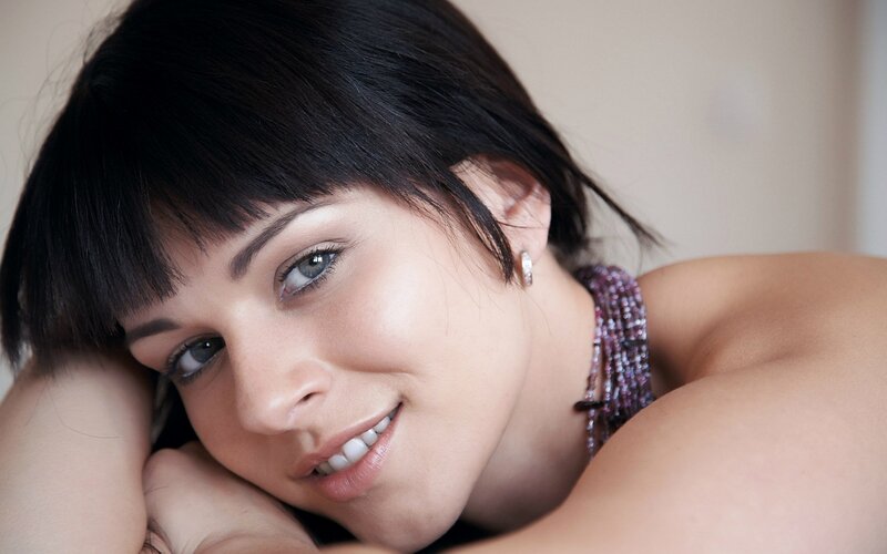 woman with dark hair smiling