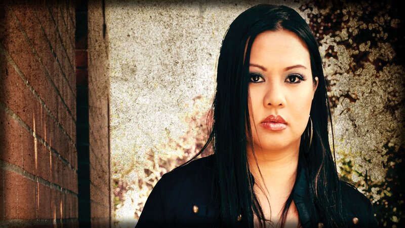 woman with dark hair standing outside