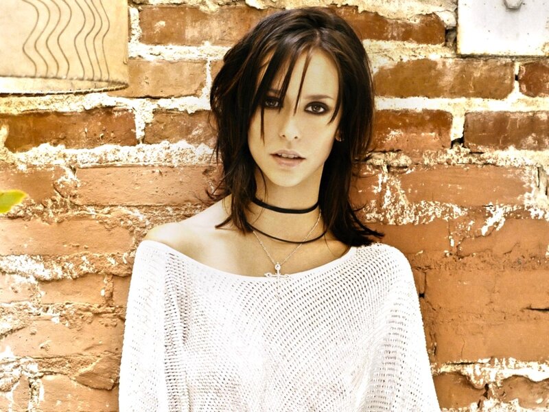 Woman with Dark Hair — White, Neutral, Photograph, Brick Wall
