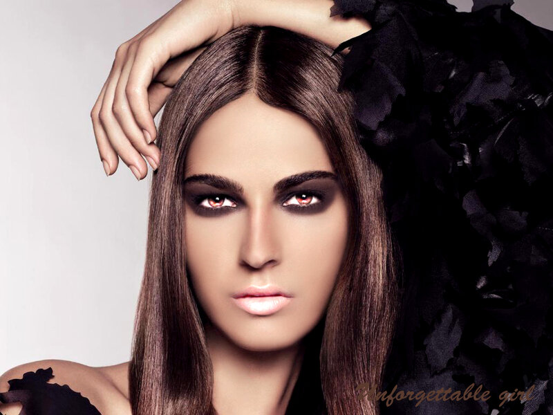 woman with dark makeup and black feathers