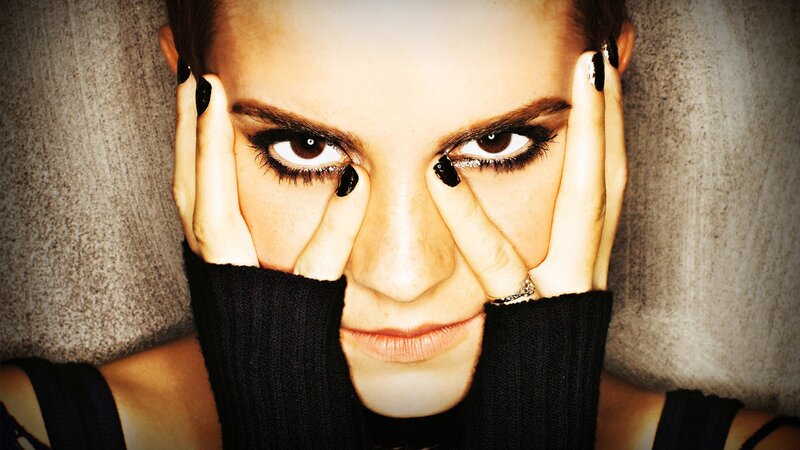 woman with dark makeup and black nails