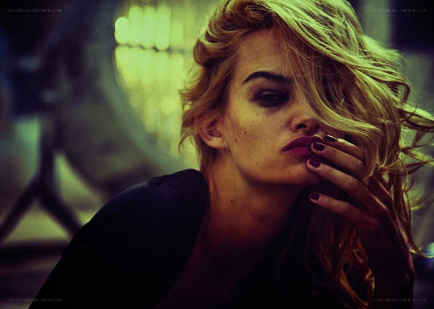 woman with dark makeup and blonde hair