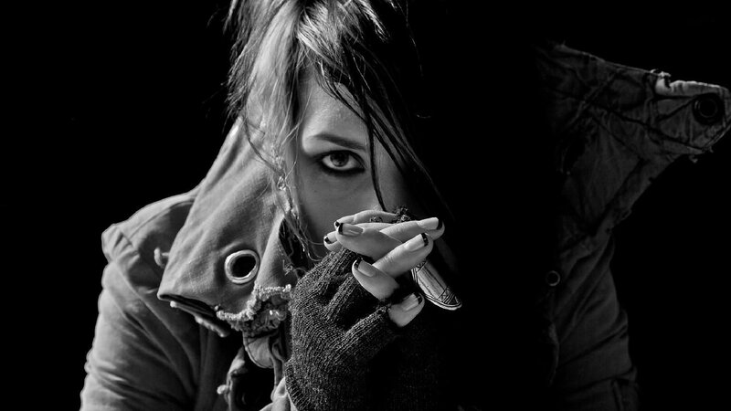 woman with dark makeup and coat