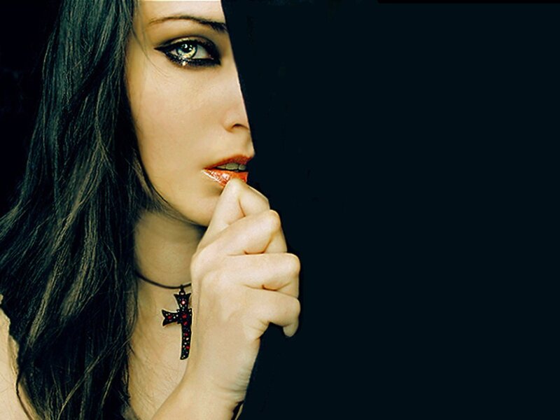 woman with dark makeup and cross necklace