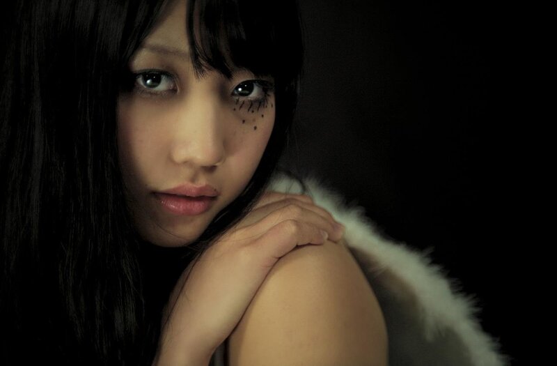 woman with dark makeup and fur