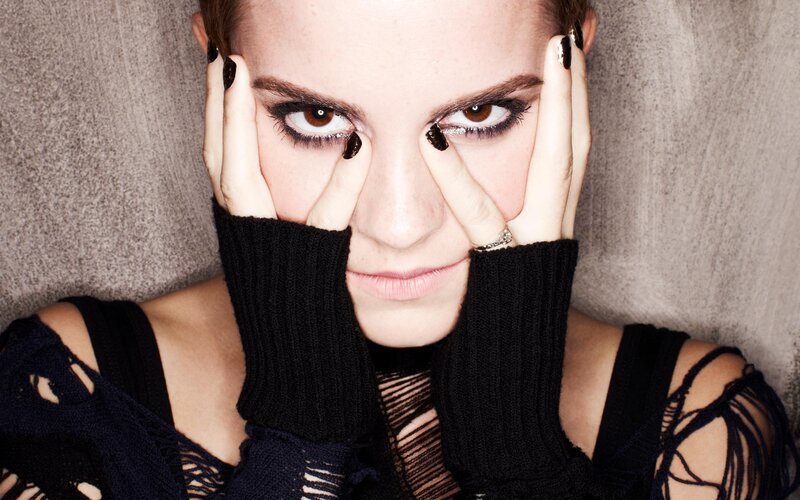 woman with dark makeup and gloves