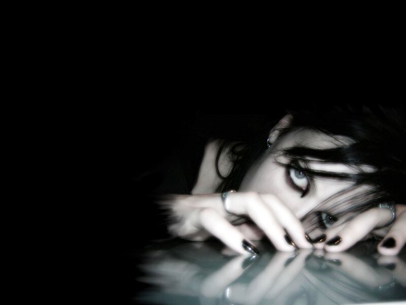 woman with dark makeup and nails