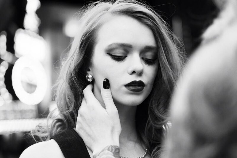 woman with dark makeup and nails