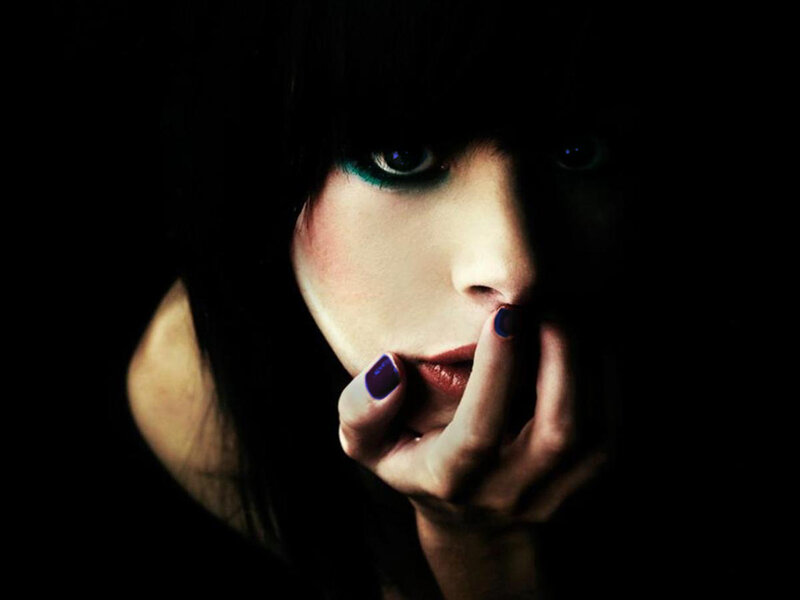 woman with dark makeup and nails