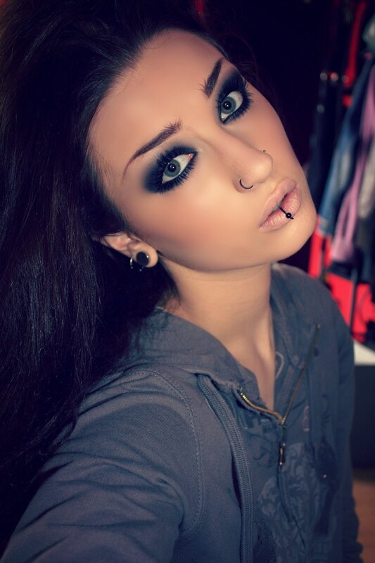 woman with dark makeup and piercings