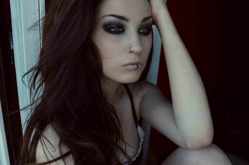 woman with dark makeup and piercings