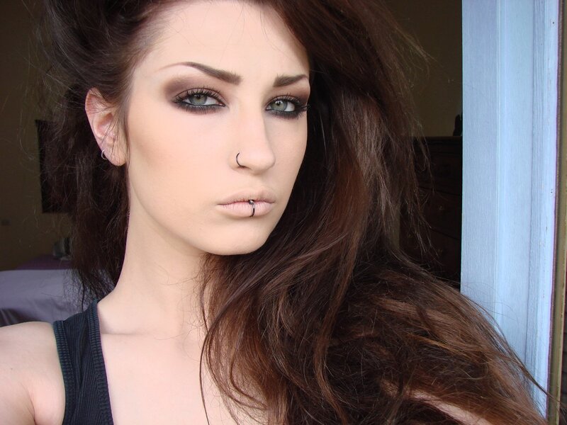 woman with dark makeup and piercings