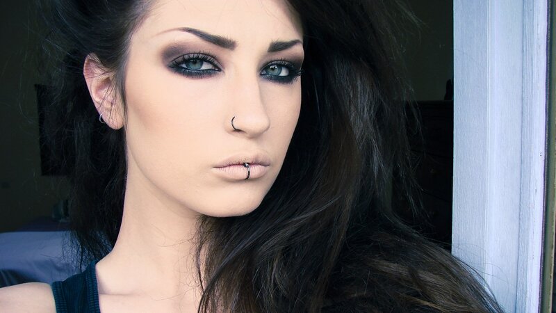 woman with dark makeup and piercings
