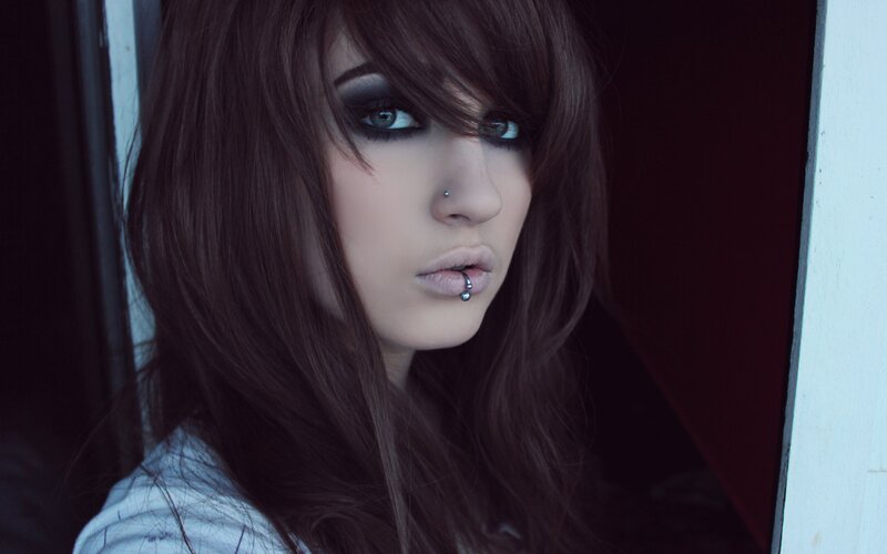 woman with dark makeup and piercings