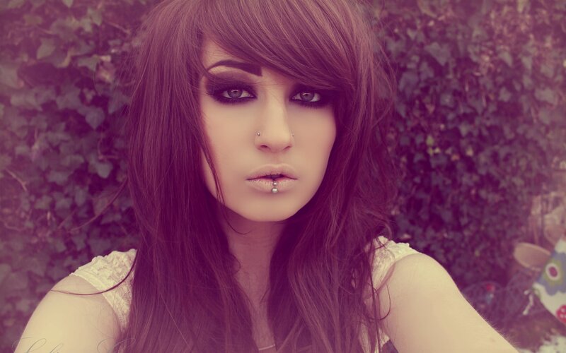 woman with dark makeup and piercings