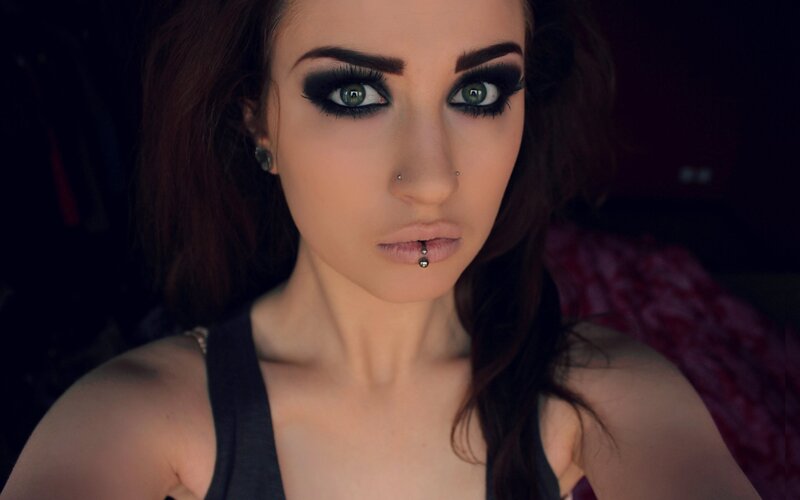 woman with dark makeup and piercings