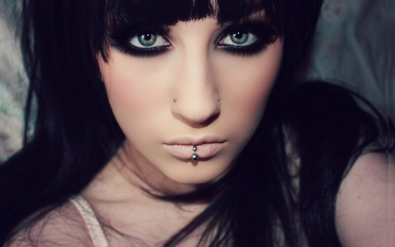 woman with dark makeup and piercings