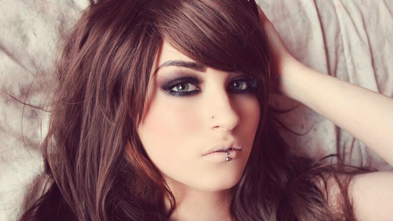 woman with dark makeup and piercings