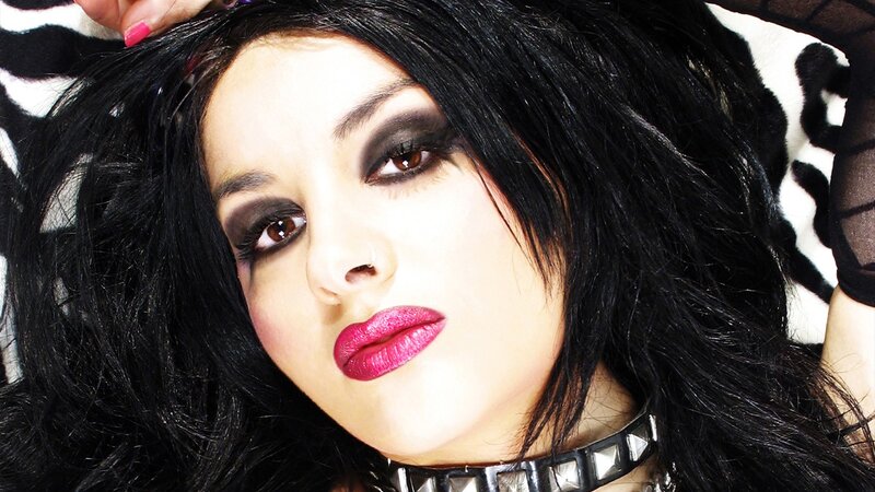 woman with dark makeup and pink lipstick