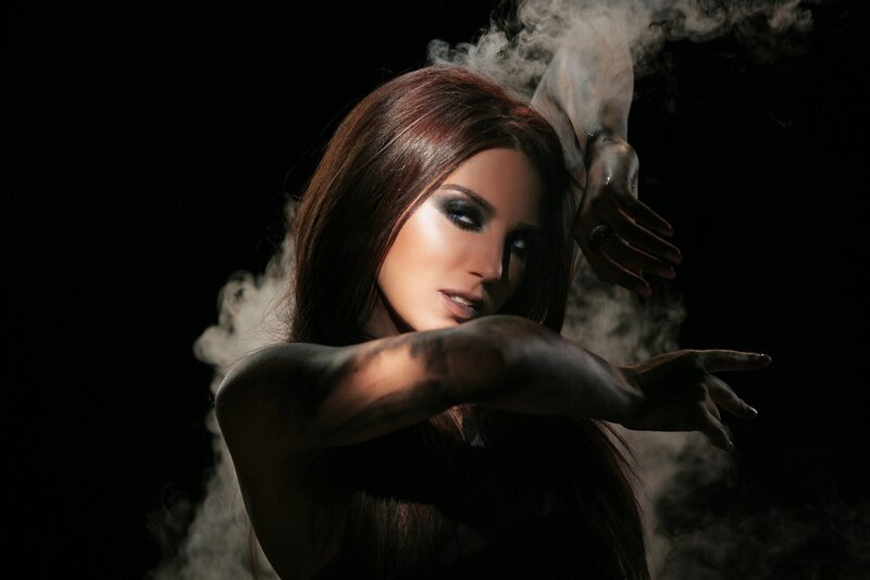 woman with dark makeup and smoke