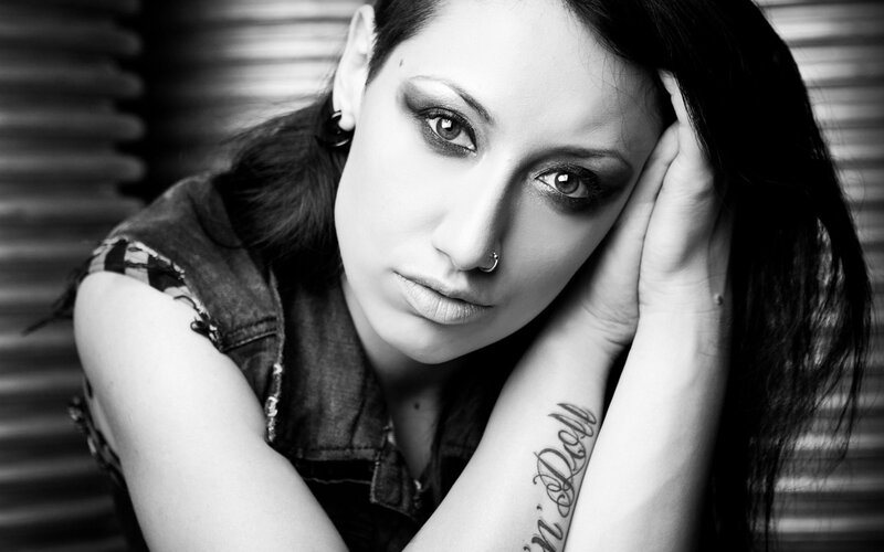 woman with dark makeup and tattoo