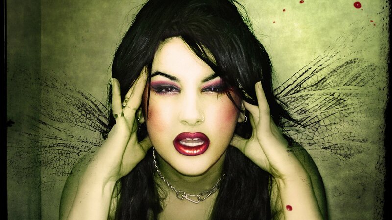 woman with dark makeup and wings