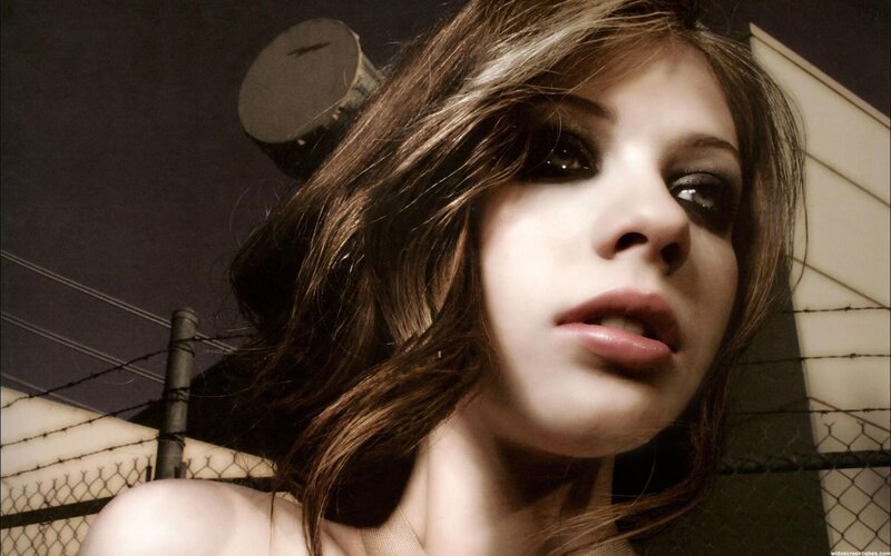 woman with dark makeup at night