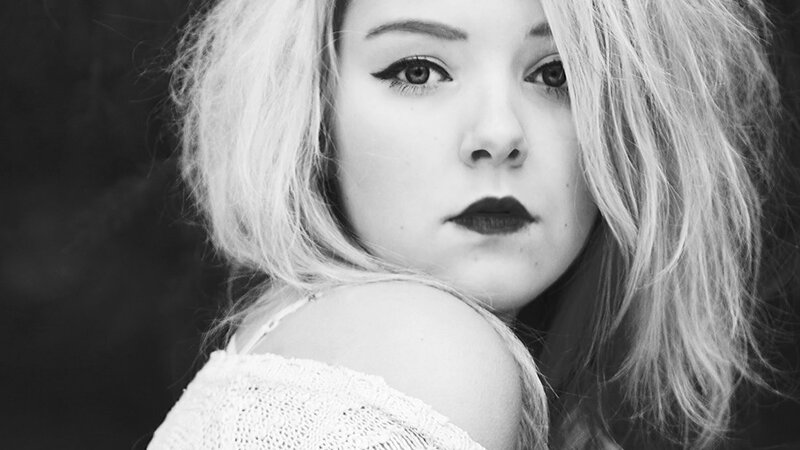 woman with dark makeup in black and white