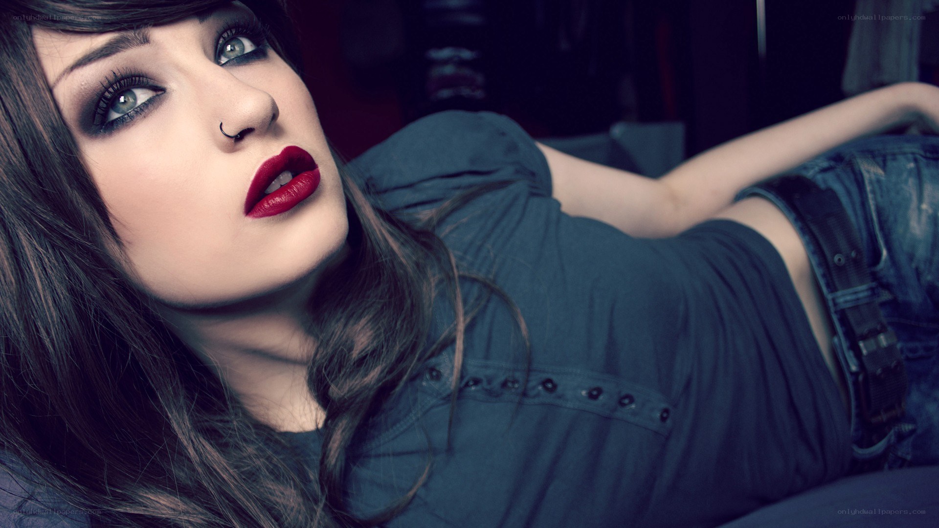 woman with dark makeup lying down