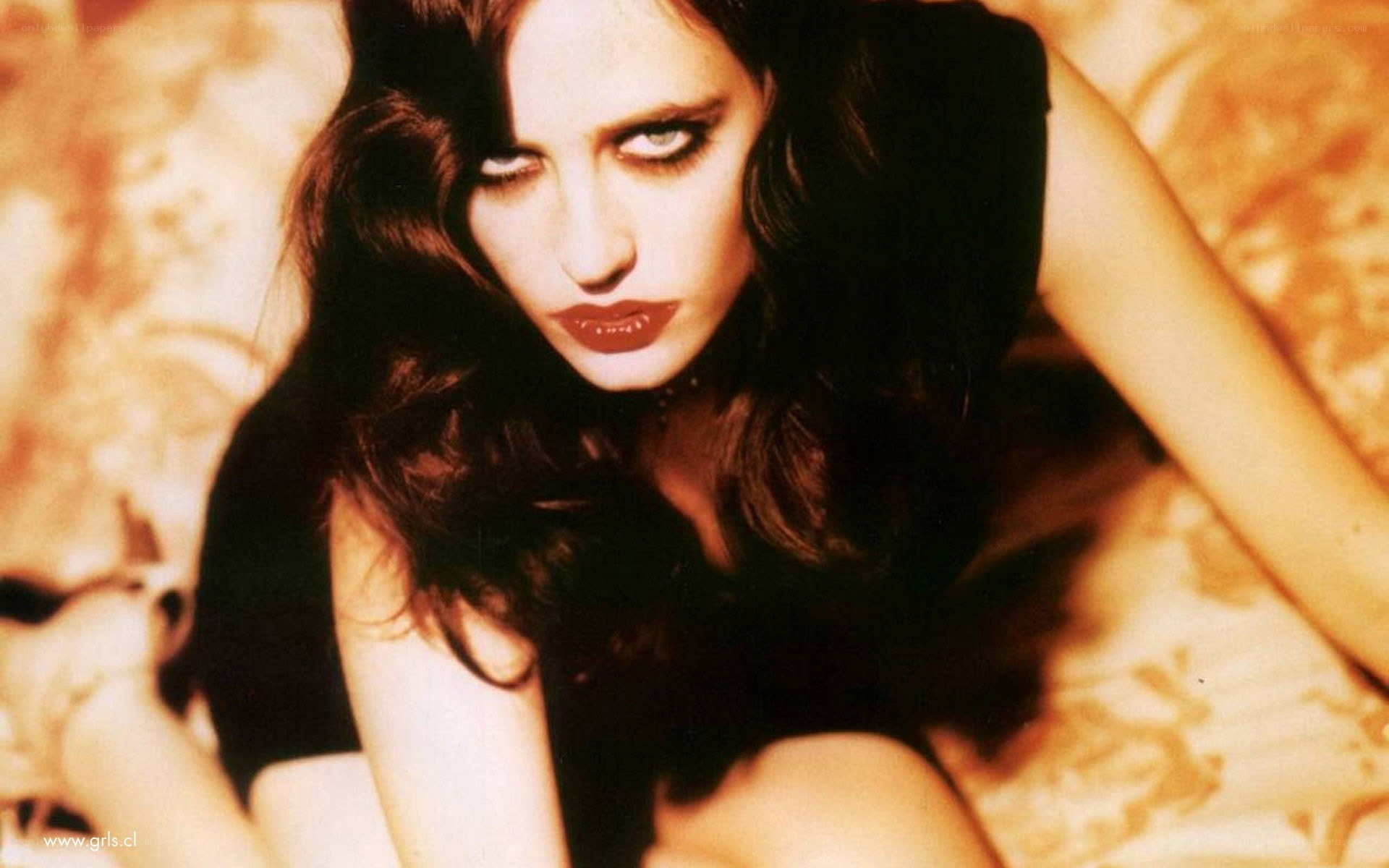 woman with dark makeup lying down