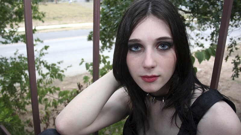 woman with dark makeup on balcony