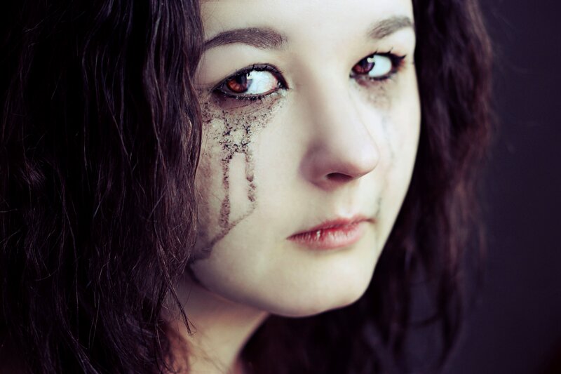 woman with dark makeup on face