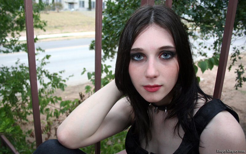 woman with dark makeup sitting outside