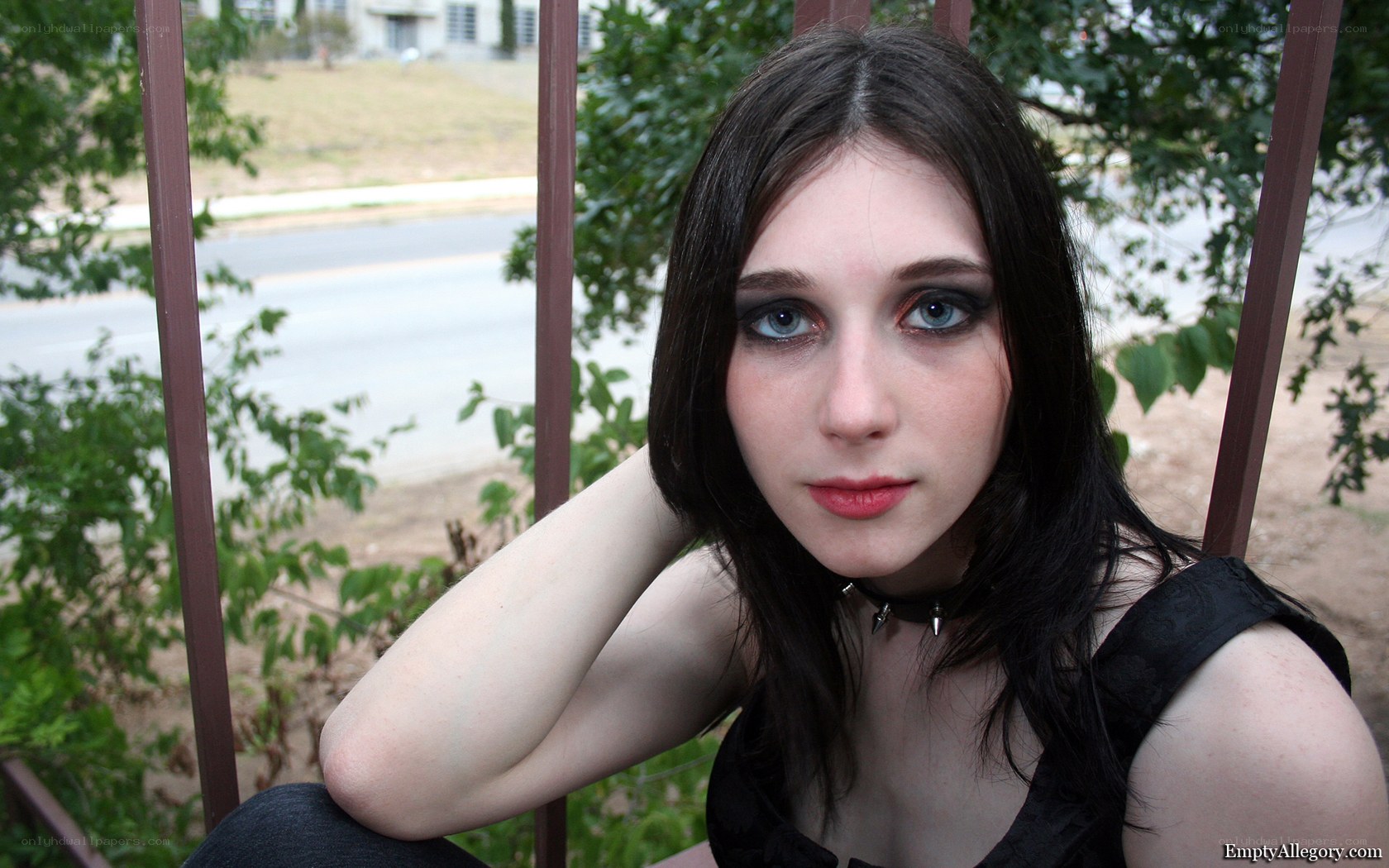 woman with dark makeup sitting outside