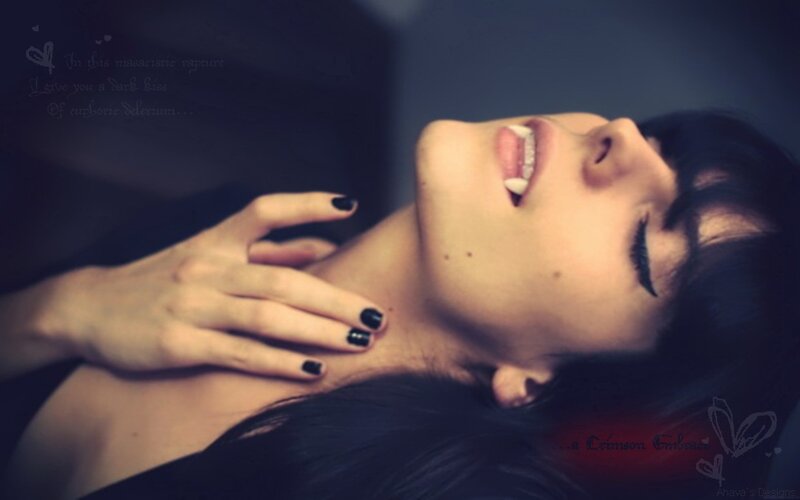 woman with dark nails and fangs