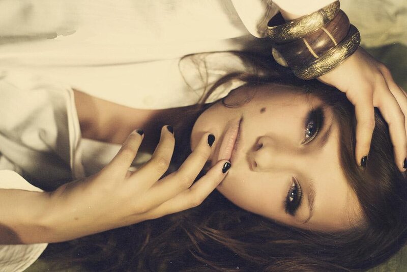 woman with dark nails lying down