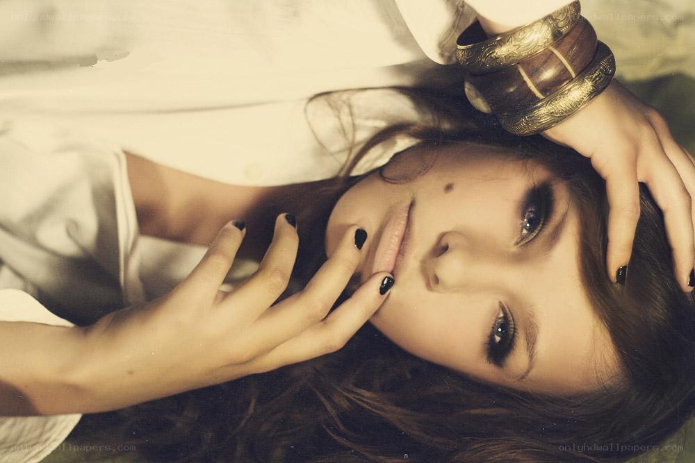 woman with dark nails lying down