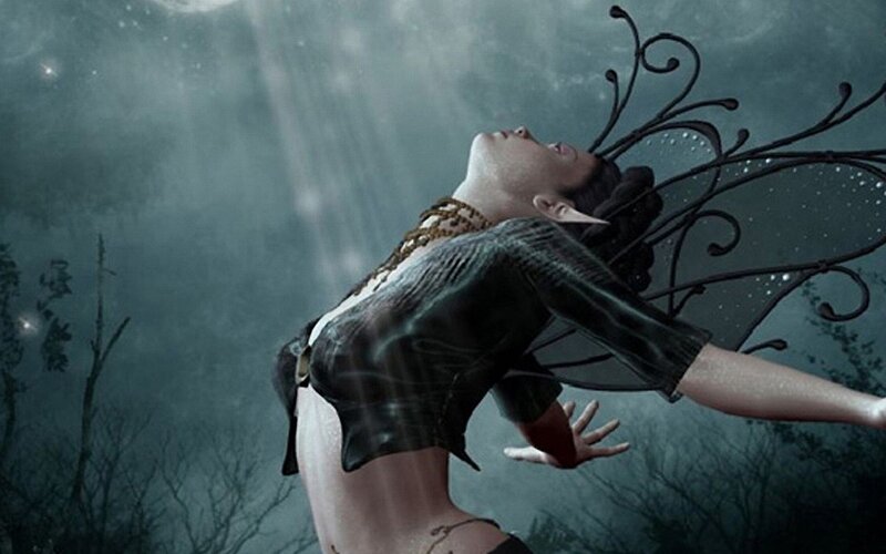 woman with dark wings in mist
