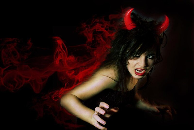woman with devil horns and red smoke