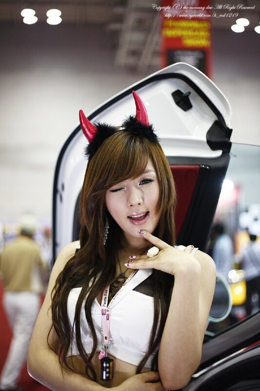 Woman with devil horns at car show