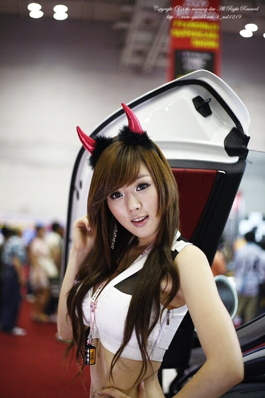 Woman with devil horns at car show