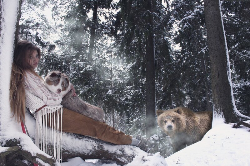 Woman with dog and bear in snow