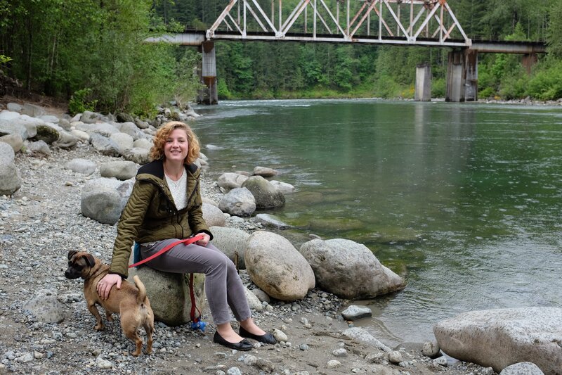 Woman with dog by river