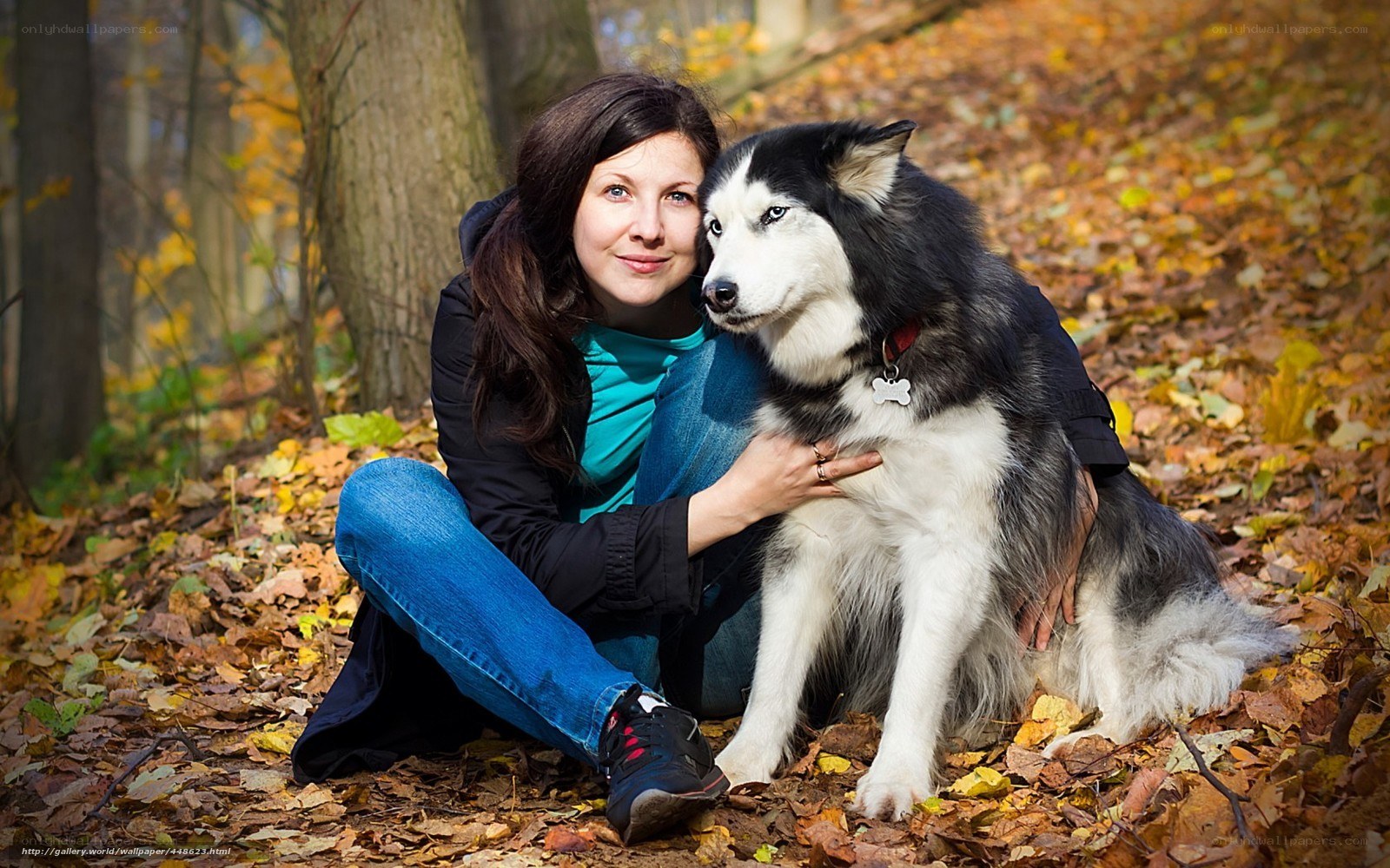 Woman with dog in autumn forest